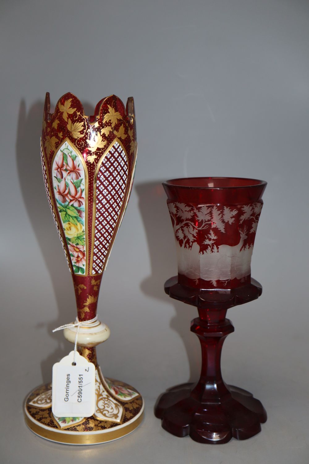 A Bohemian etched ruby glass goblet, together with a gilded cranberry glass vase, tallest 29cm